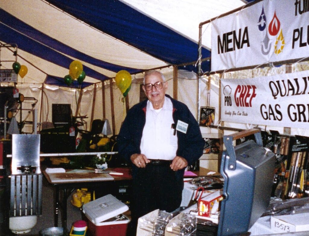 Image of Mena Plumbing founder, Ambrose Mena, at Mena Plumbing vendor booth.